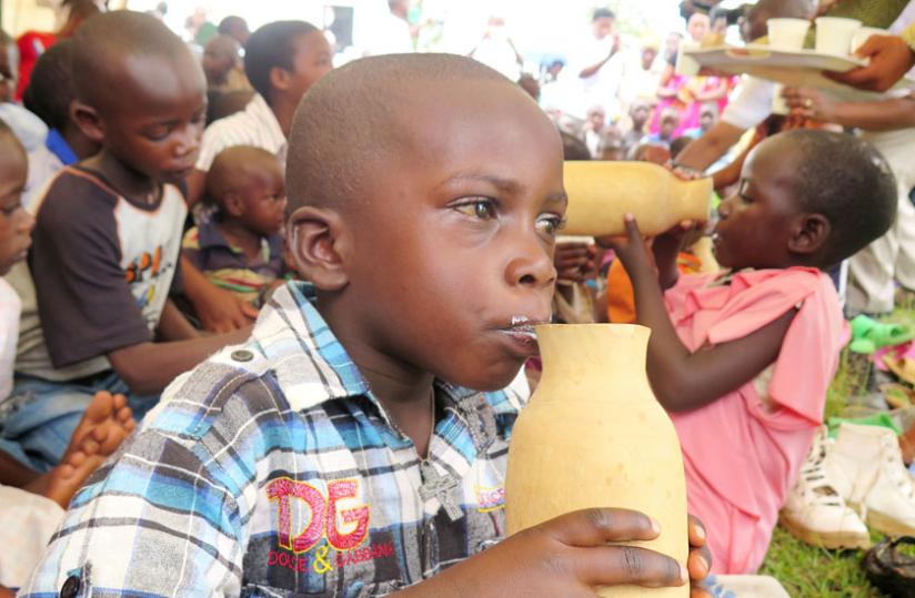 A boy takes a swig from a milk jar as part of the Girinka Week in Huye. (JP Bucyensenge)