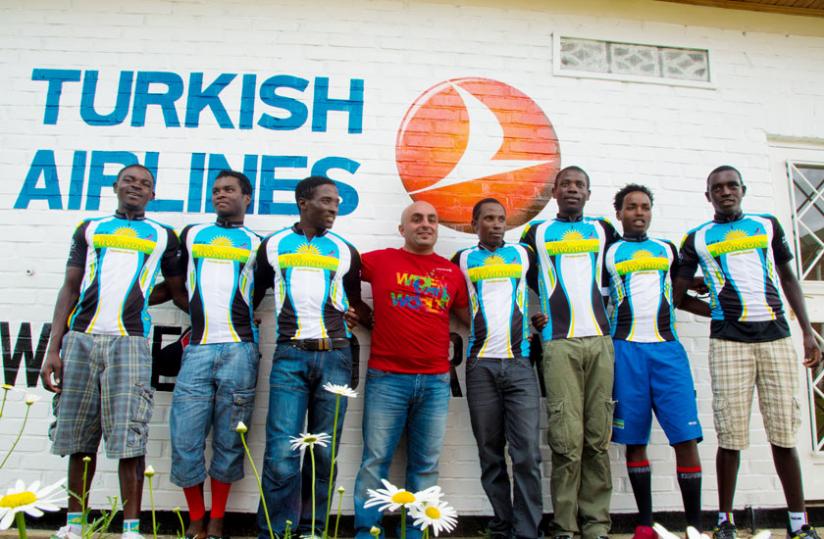 Turkish Airlines country manager Burcin Isler (C) in a group photo with Team Rwanda cyclists. (Timothy Kisambira)