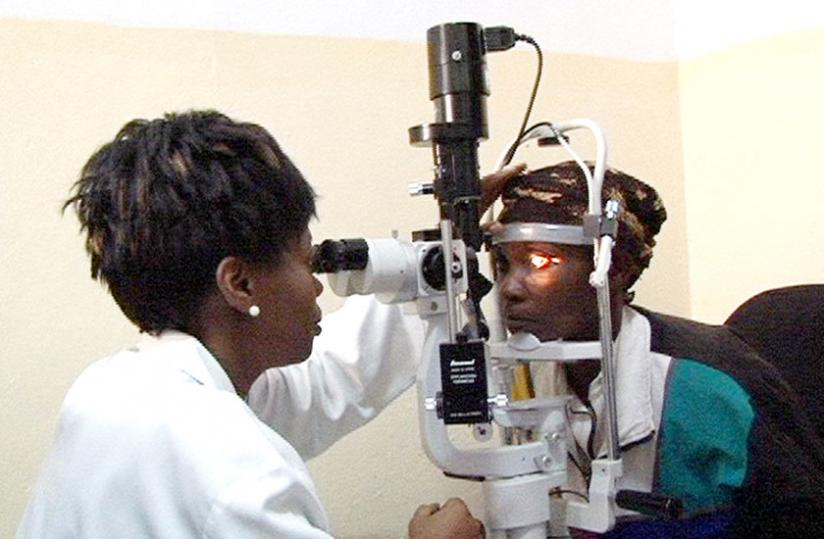 An oculist examines the eye of a patient. (Jean d'Amour Mbonyinshuti)