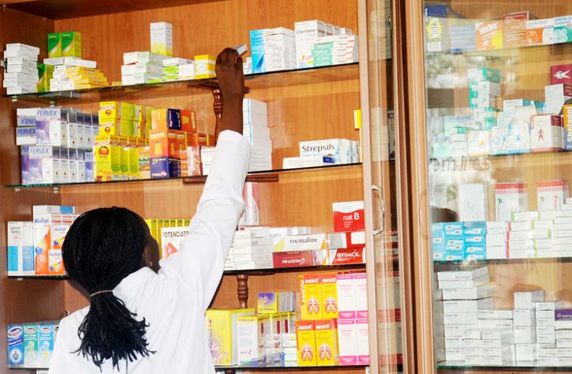 A pharmacist picks drugs from a shelf. (File)