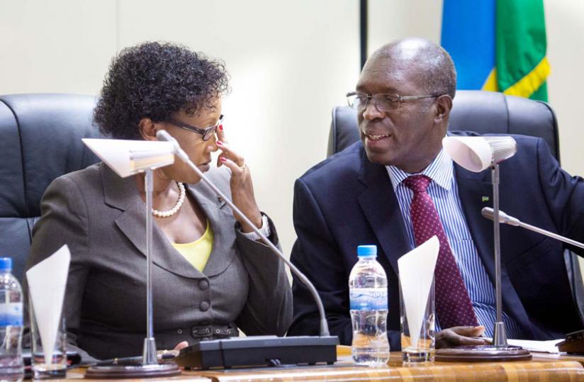 The Minister of Cabinet Affairs, Stella Ford Mugabo (L), chats with Murekezi at Parliament yesterday. (Timothy Kisambira)