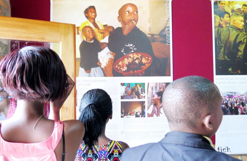 Visitors admire some of the photos on exhibition at the Ethnographic Museum in Huye. (Jean Pierre Bucyensenge)