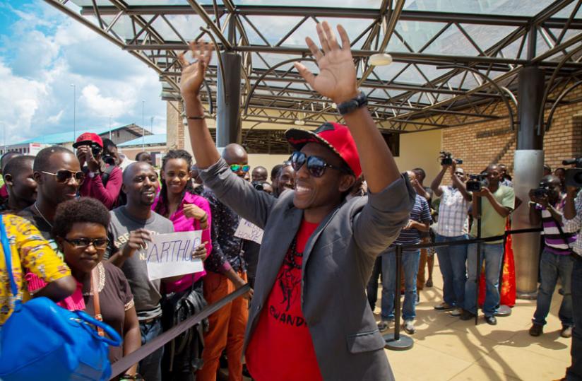 Rwandau00e2u20acu2122s Hotshot Arthur waves at fans upon his arrival at Kigali international airport (Timothy Kisambira)