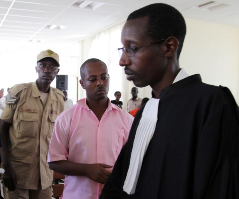 Kizito Mihigo with one of his Lawyers, John Bigarama, in  an earlier court session. File
