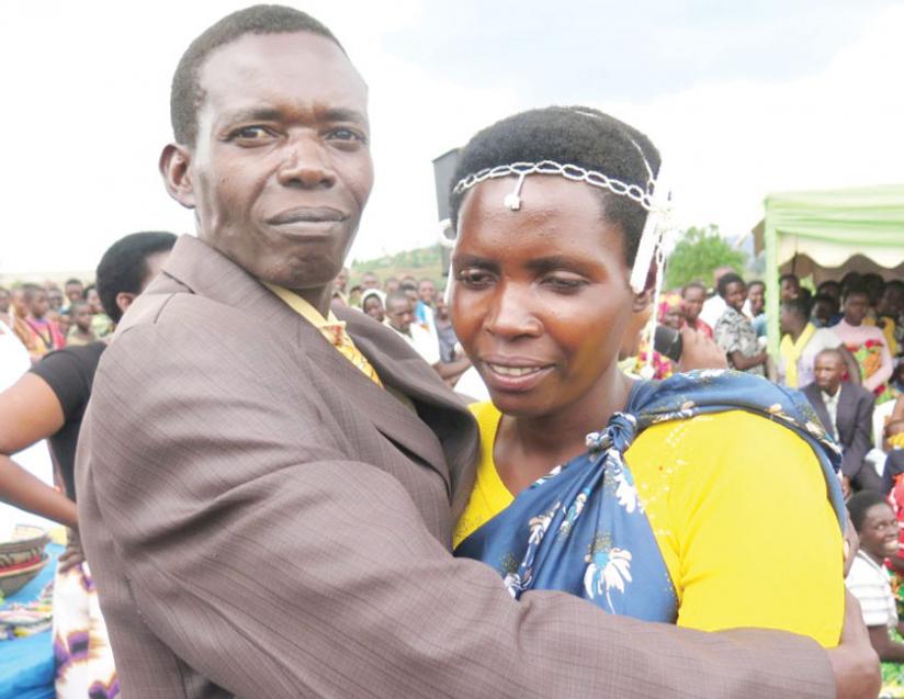 Misago and his wife Mukantabana hug. Their family had been broken by incessant conflicts  but now  they have buried the past and moved on with life. (P. Bucyensenge