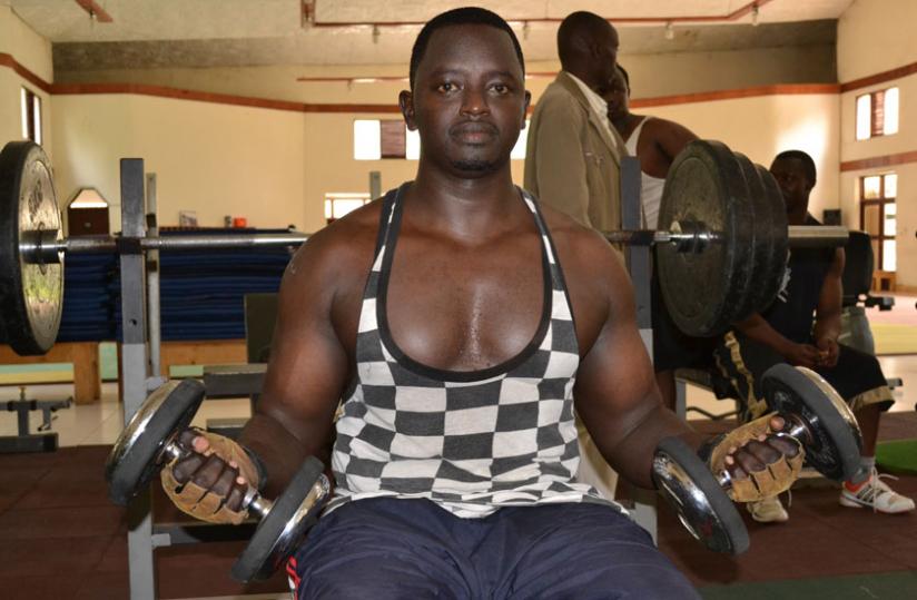 Mushumba lifts weights at the gym. (Moses Opobo)