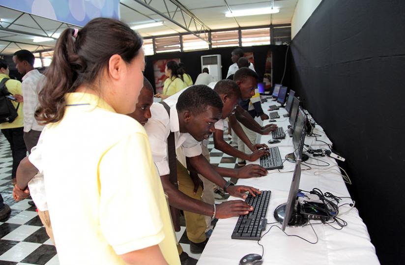 Youth try out some computer applications at an ICT expo organised by the Korean Embassy in Kigali last month. (John Mbanda)