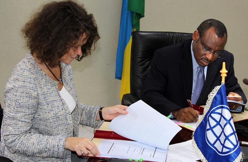 Carolyn Turk (left) and Minister Gatete at the signing of the deal yesterday. (Courtesy)