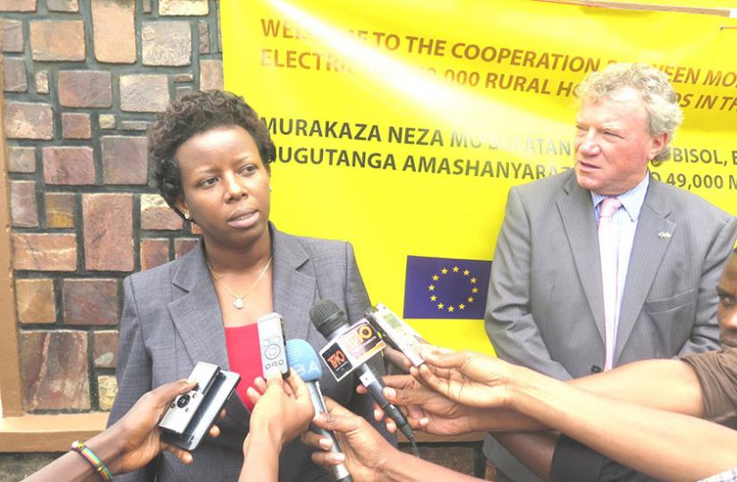 Minister Germaine Kamayirese talks to journalists as EU Ambassador Macheal Ryan looks on.(Stephen Rwembeho)