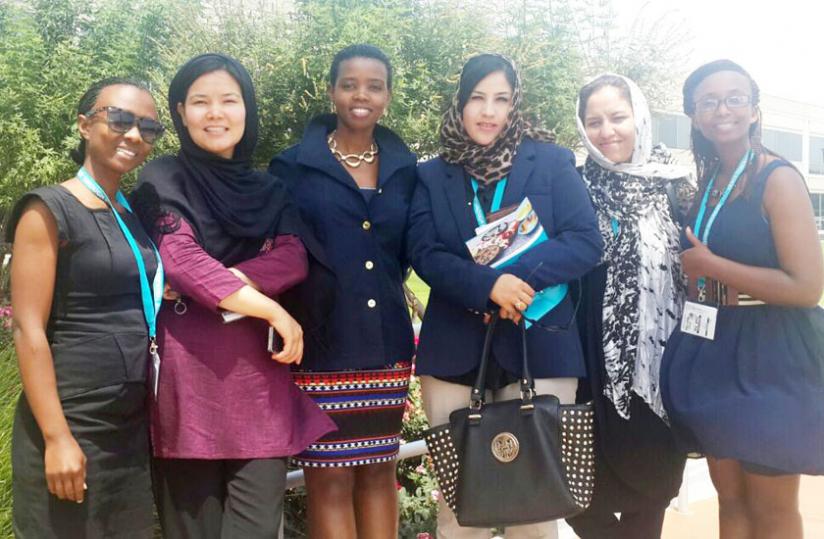 Businge (centre) with Rwandan and  Afghanistan women after a summit in the US during the Peace through  Business course.