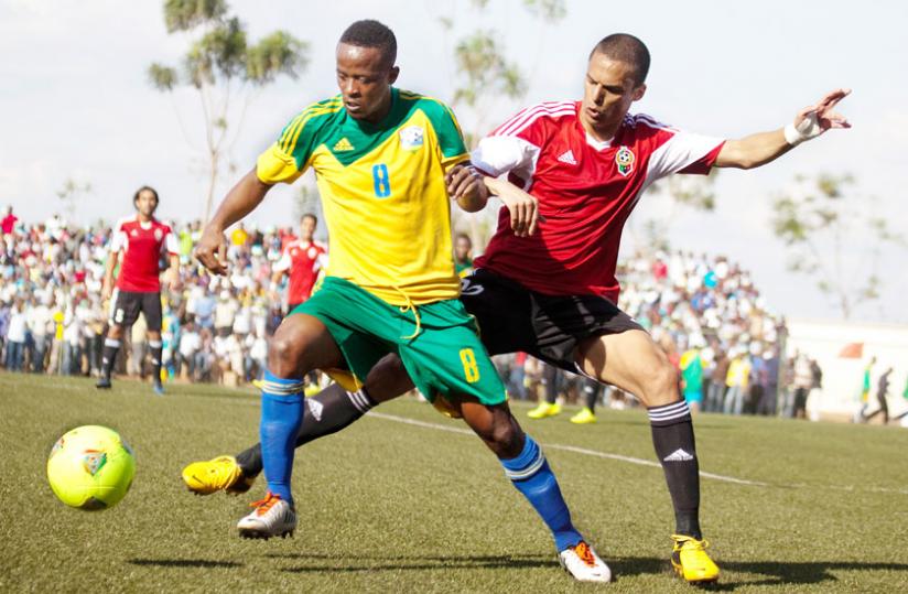 Amavubi captain Haruna Niyonzima takes on a Libyan defender in the 2015 Afcon qualifiers. The midfielder thinks the youthful Amavubi team is good enough to beat Morocco. (File)