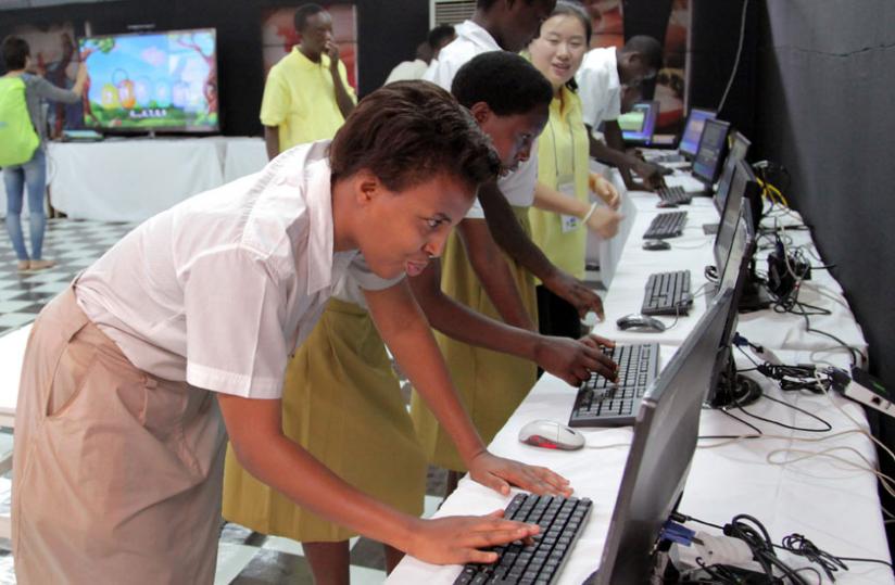 Students try out some computer applications at an ICT expo in Kigali last month. (John Mbanda)