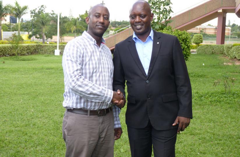 New Rugby Federation President Alex Araire (L) being congratulated  by his predecessor Dr Otto Vianney Muhinda  after being elected for a four-year term last week. (File)