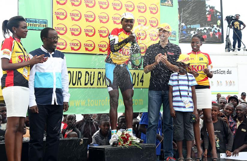 Rwandau00e2u20acu2122s Janvier Hadi (popping champagne) won yesterdayu00e2u20acu2122s 3.5km- prologue of the 2014 Tour of Rwanda, running the distance around the Amahoro National Stadium in four minutes and four seconds.(John Mbanda)