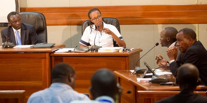 Probe team chair Ngoga (L) and commissioner Rosine Urujeni listen to Muvunyi as he testified on the first day of the commission hearings at Telecom House yesterday. (Timothy Kisambira)