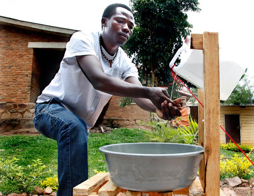 A resident of Kicukiro washes his hands after visiting the toilet. (File)
