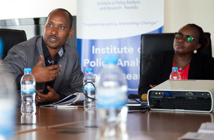 Dr Alfred Bizoza (L), Director of Research IPAR-Rwanda explains to journalists the research findings as Kayitesi looks on yesterday.  (Doreen Umutesi)