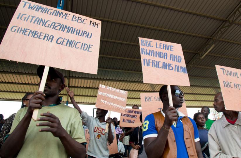 Protesters hold placards at Kicukiro, in a demo against BBC, earlier this month. (Timothy Kisambira)rn