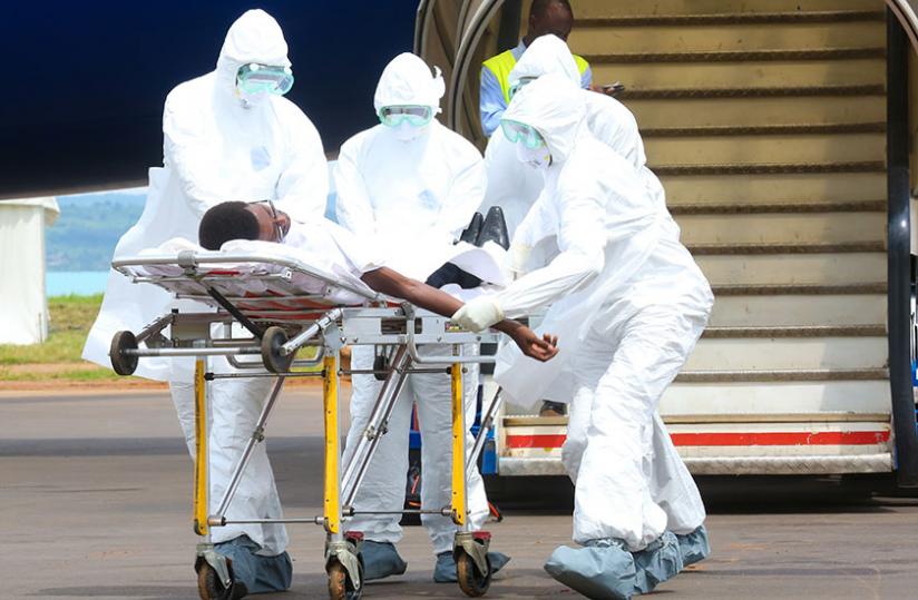 Medics from Kanombe Military Hospital show how to evacuate Ebola patient from a plane to hospital. (Timothy Kisambira)