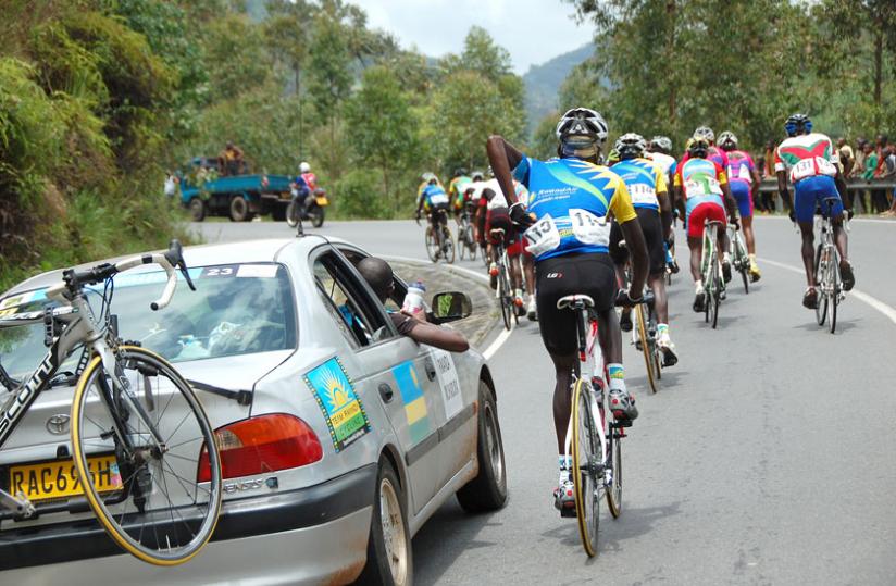 Aime Mupenzi, from Team Akagera tries to eat some bananas and take some water as the riders race to Rubavu during stage 5.