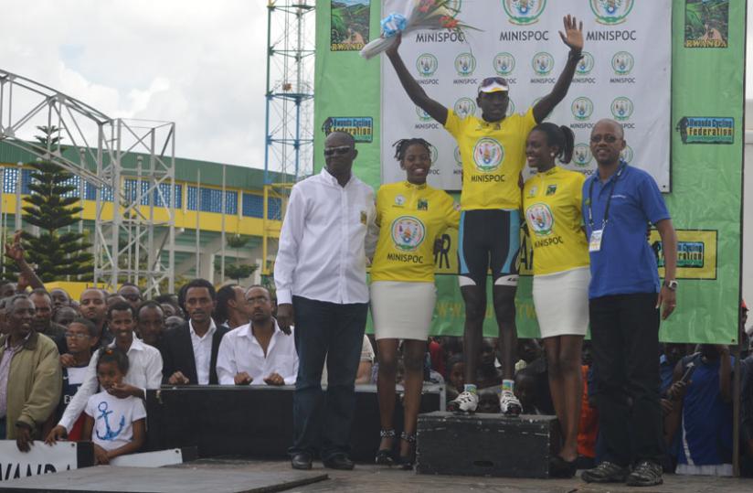 Ndayisenga after being crowned winner of  the sixth edition of Tour du Rwanda on Sunday. Left is Sports minister Joseph Habineza while , right, is cycling federation chief Aimable Bayingana. (Peter Kamasa)