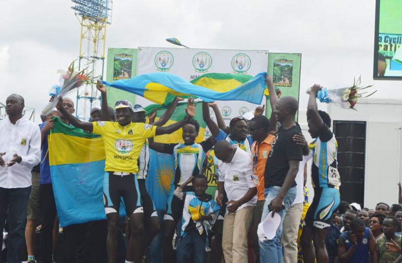 Valens Ndayisenga (in a yellow jersey) celebrating with Team Rwanda after winning our du Rwanda. (Peter Kamasa)