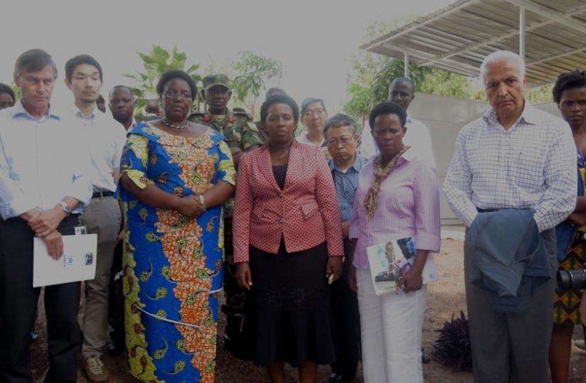 Minister Mukantabana (with arms folded) and the diplomats at Nyabiheke  camp on Monday.  (File)rn