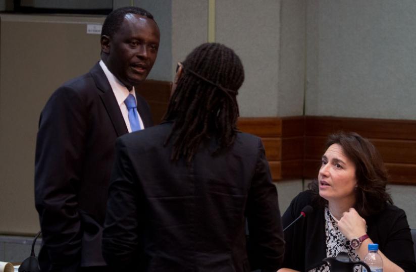Ngoga (L), chats with comissioner Rosine Urujeni as Cameron looks on at Telecom House in Kigali yesterday. (Timothy Kisambira)