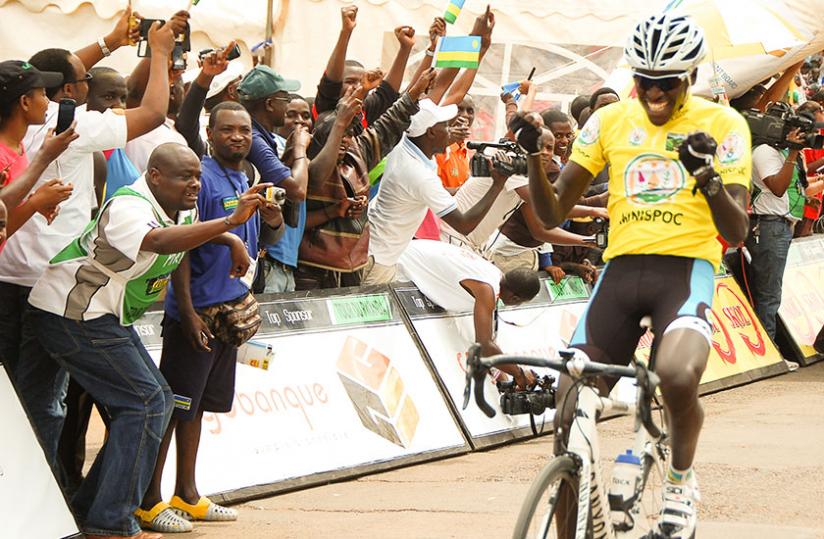 Valens Ndayisenga celebrates as he crosses the finish line on his way to winning the 2014 Tour du Rwanda. (Timothy Kisambira)