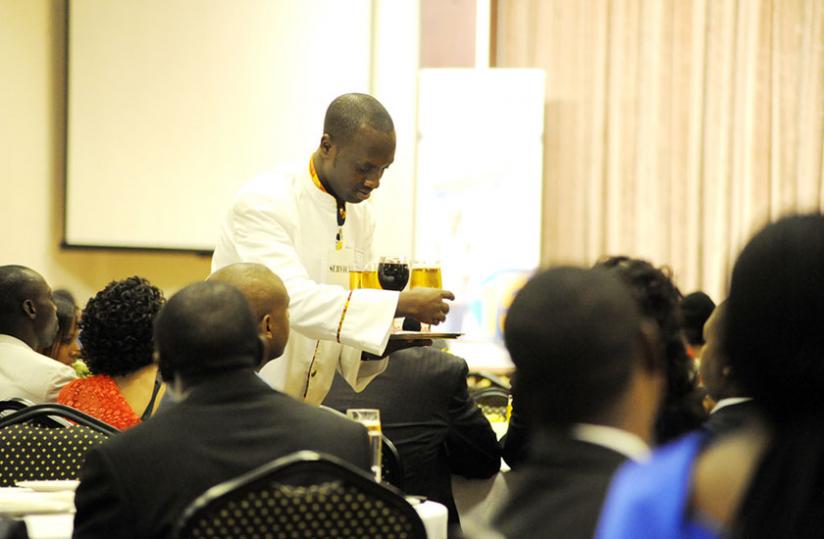 A waiter at a Kigali hotel serves guests; The forum will be an opportunity for stakeholders to tap into best practices from the region and beyond to grow their businesses. (File)