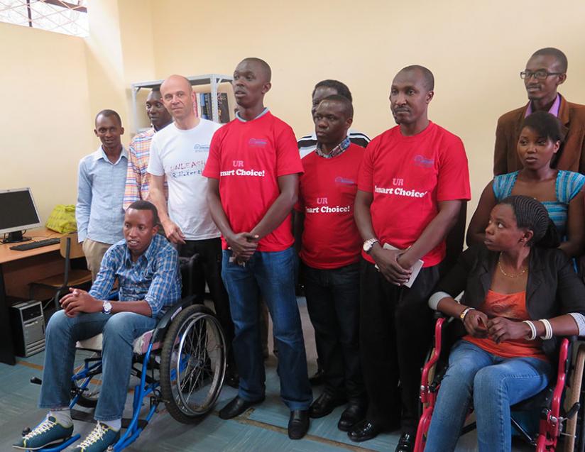 Some CMHS students and staff at the inauguration of  the lab  for disabled students. (Emmanuel Ntirenganya)