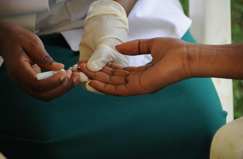A volunteer tests for HIV/Aids at King Faisal Hospital, Kigali.  A new study shows that HIV may be naturally evolving into a milder and less fatal virus. (File)