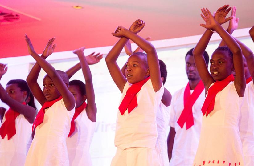 Mashirika Arts-trained pupils of New Life Ministry, wearing the HIV/Aids awareness ribbon, perform at the International HIV Research Conference in Kigali yesterday. (Timothy Kisambira)