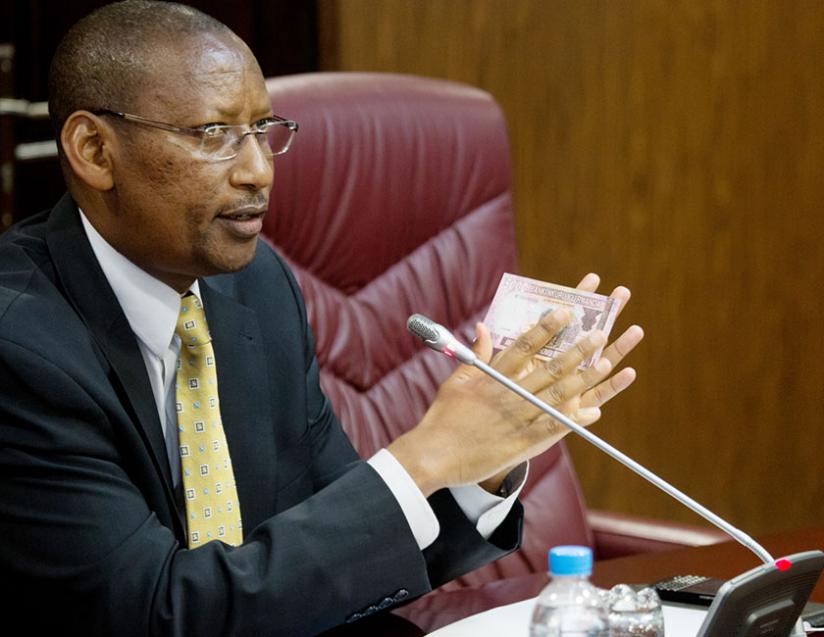 Rwangombwa shows the new Rwf5,000 note to journalists in Kigali yesterday. (Timothy Kisambira) 