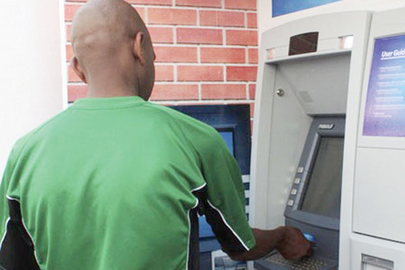 A person withdraws money from an ATM. (File)rn