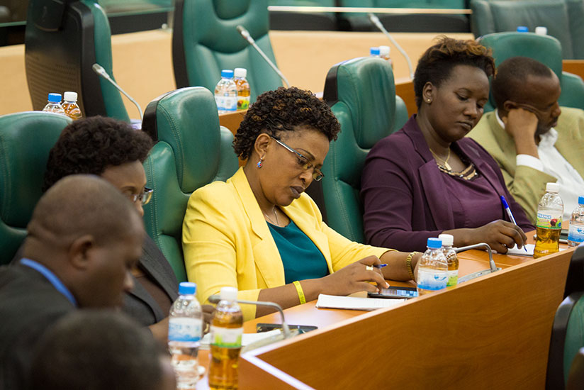 Members of Parliament take notes during the press briefing. (Timothy Kisambira)
