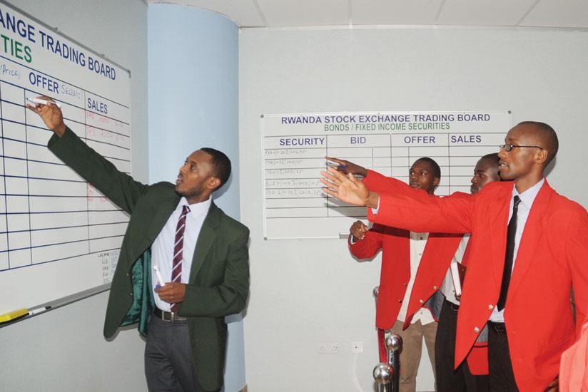 Dealers transact business in this file photo. The bourse is tipped to perform better in the New Year. 