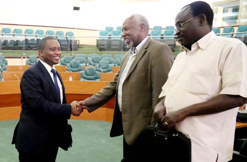 The Minister of State in charge of Primary and Secondary Education, Olivier Rwamukwaya (L), interacts with Senators Emanuel Bajyana (C) and Jean Nu00c3u00a9pomuscu00c3u00a8ne Sindikubwabo after a consultative meeting with senators in the senatorial Standing Committee on Social Affairs, Human Rights and Petitions in Parliament yesterday. (John Mbanda)
