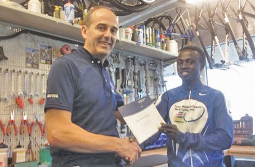 Rafiki Uwimana gets his certificate  from a trainer after completing a mechanics course in Switzerland last year.