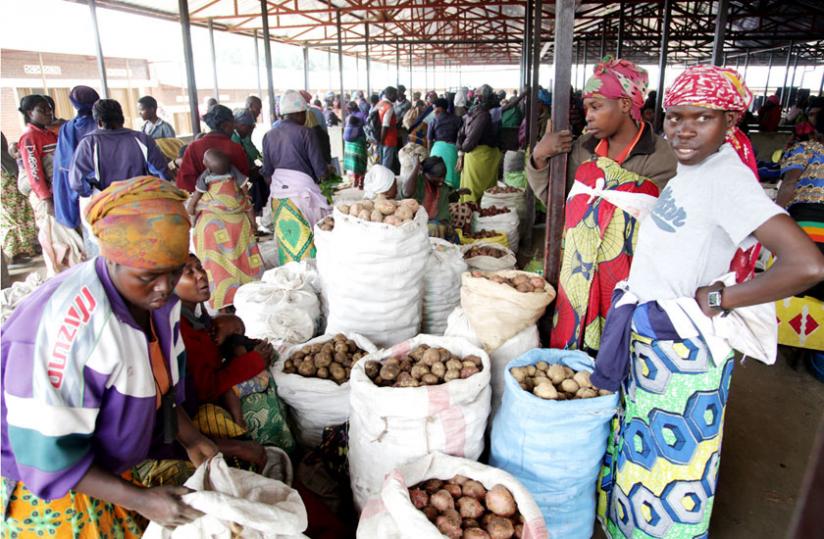 Women sell potatoes in Byangabo market in Musanze District last May. (John Mbanda)
