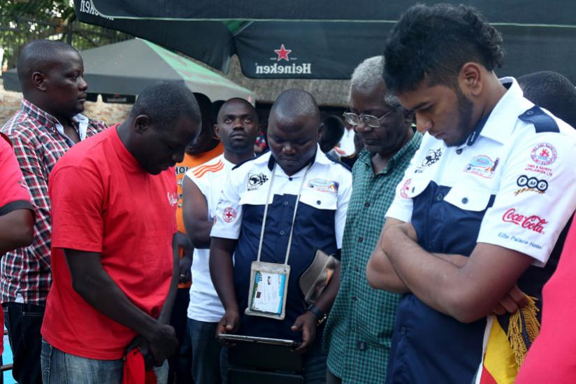 Rally drivers observe a minute of silence after the shock death of Christophe Dusquene who died in a car accident in the Rally des Mille Collines yesterday. (John Mbanda)