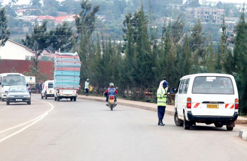 A Traffic Police officer examines a driveru00e2u20acu2122s documents. At least 70 people were arrested over attempt to bribe officers in the last three months. (File)