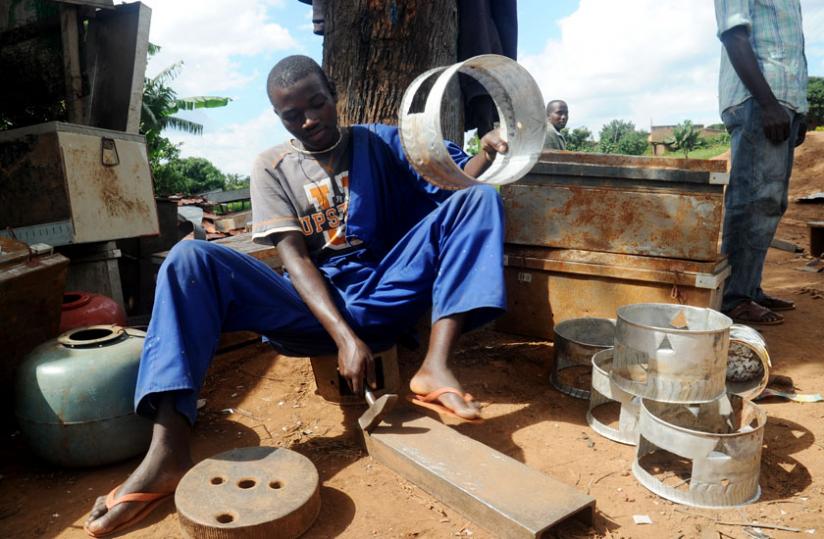A youth makes charcoal stoves at Gakingiro in Kigali on May 31, 2009. (File)