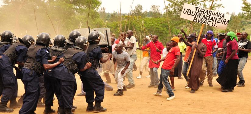 Police officers attempt to restrain a crowd during a mock protest  in Bugesera District yesterday. (Courtesy)