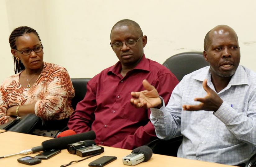 Rugira (R)  addresses journalists as Hakizimana (C) and Mukanteri look on at a news briefing on Wednesday. (John Mbanda)