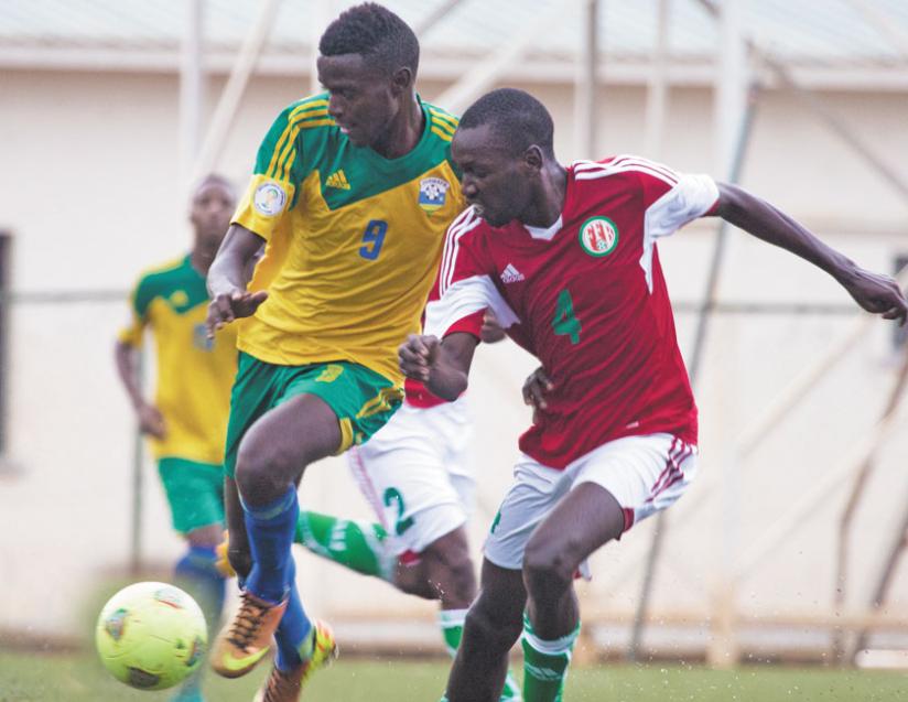 Young striker Bertrand Iradukunda, left, out-muscles a Burundian opponent during Saturday's international friendly match. (T. Kisambira)