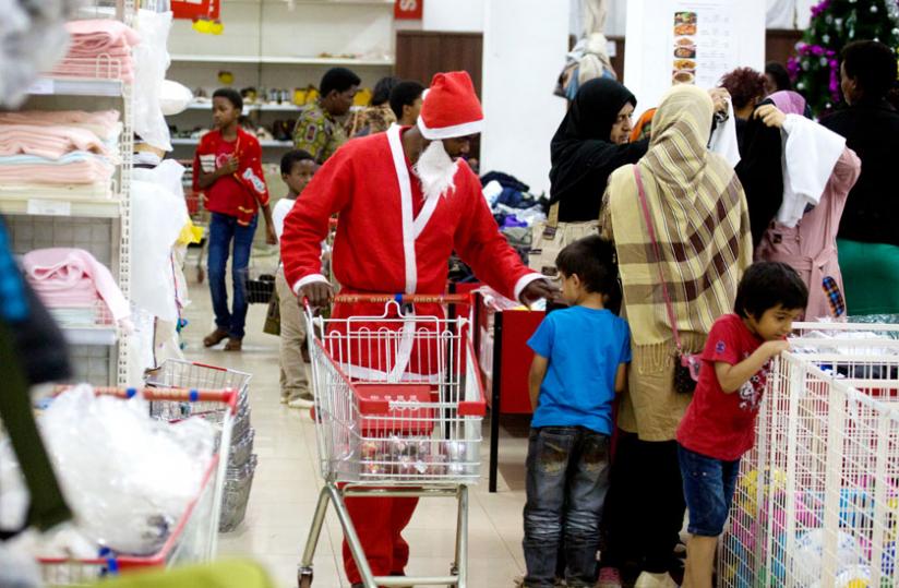 A man dressed as Santa pokes a child inside T2000 supermarket in Kigali.(Timothy Kisambira)