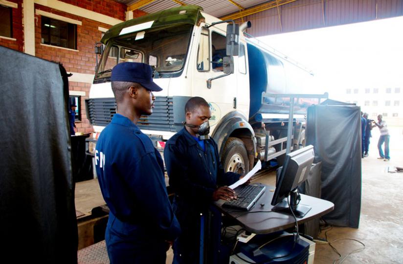 Traffic Police check a lorry at the Motor Vehicle Control Unit in Remera. (Timothy Kisambira)
