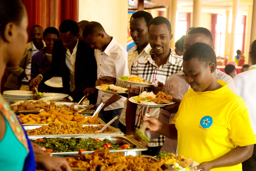 Some of the youth serve themselves a meal yesterday. (Timothy Kisambira)