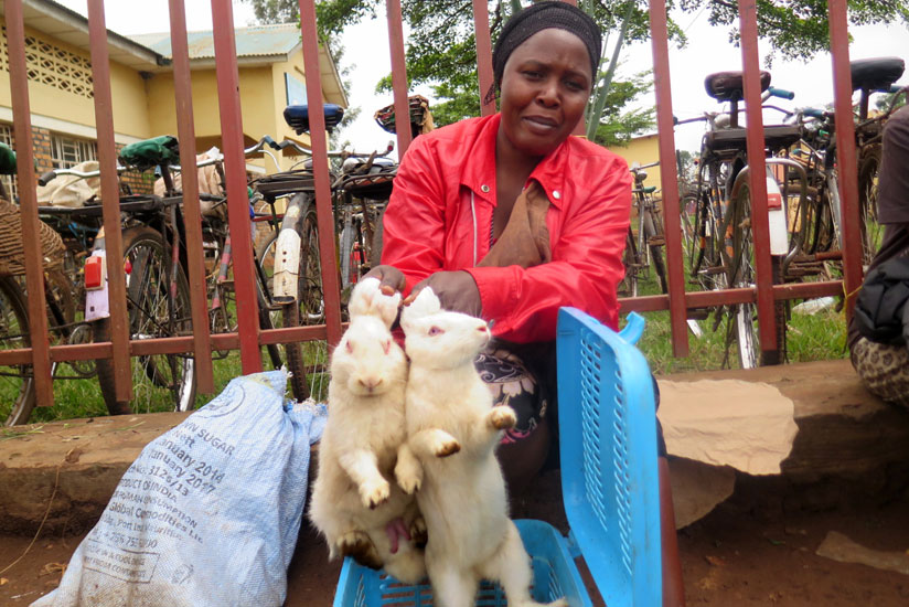 Mukashyaka with her rabbits at a local market in Rwamagana. (Stephen Rwembeho)
